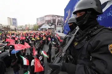 Security personnel stand guard as Iranians take part in a protest marking the annual al-Quds Day (Jerusalem Day) on the last Friday of the holy month of Ramadan in Tehran, Iran, March 13, 2026. REUTERS/Alaa Al Marjani